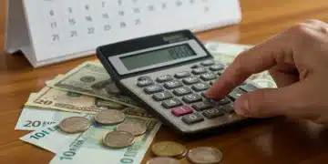 Calculator and money on table, representing financial planning for 2026 inflation