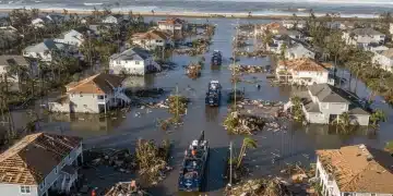 Aerial view of storm-damaged community with emergency response efforts underway.