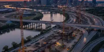 Massive infrastructure construction site with cranes and new highways
